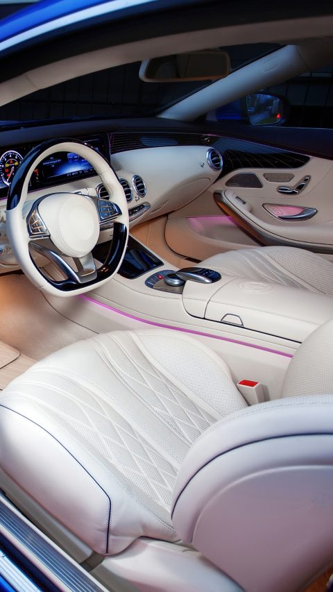 Luxury car interior. Steering wheel, shift lever and dashboard