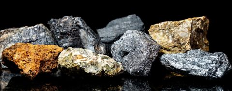 Various raw ore gemstones or rocks on black background, mining and geology, mineralogy