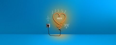 The picture shows an orange neon light in the form of a heart plugged into a blue wall. There are white sketches around it of a wind turbine, an electric heating element and the number “1562°F”.  