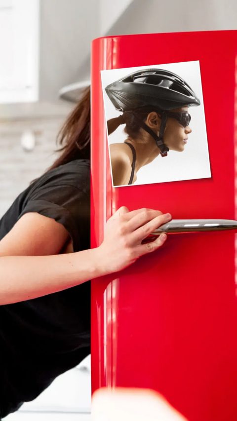 Hungry Woman looking for food in red retro refrigerator in modern bright apartments. Diet keeping concept. Loosing weight or gaining muscles. Evening hunger,