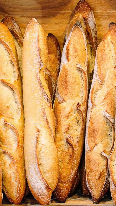 Stack of baguettes and breads in French bakery in Rhone Alpes, natural light, image taken with Nikon D800 and 24-70 lens, in RAW file format, XXXL size, developed with special attention on details.