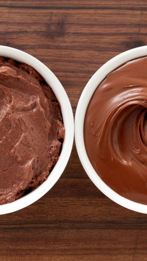 Three bowls containing soft chocolate stuff (mousse, spread and pudding)