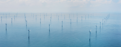 View from above showing several wind turbines in a offshore wind farm 