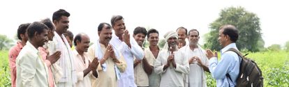 Employee with farmers in India
