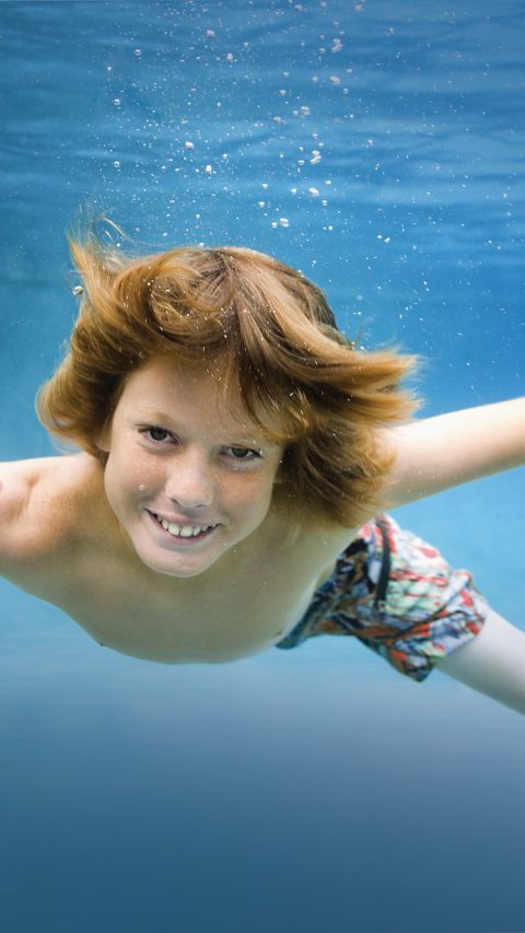 640-02765975© Masterfile Royalty FreeModel Release: YesProperty Release: NoPortrait of a boy swimming underwater