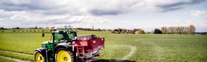 Tractor applying fertilizer on a field