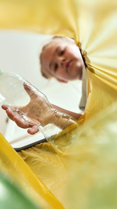 Low angle view of girl throwing a bottle, Poland, podkarpackie, DÄ bica