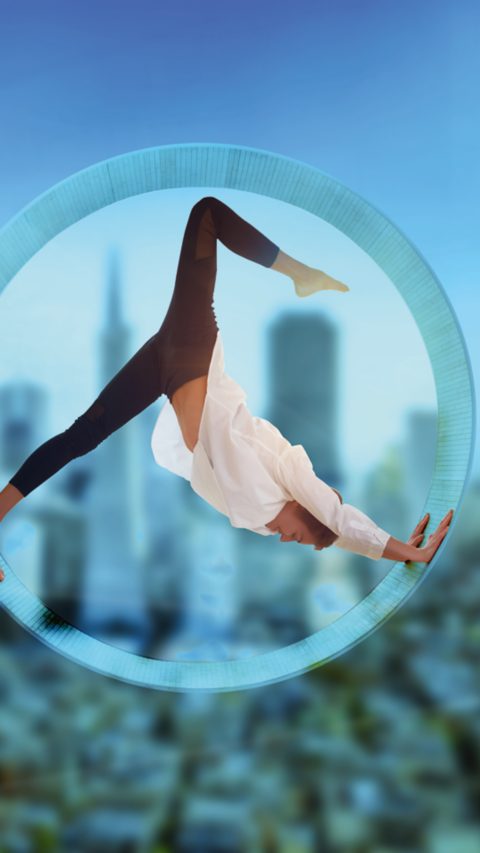 Young woman doing yoga in the round window