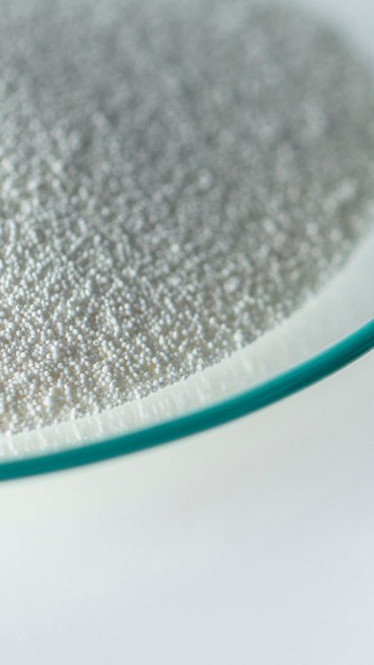 Photo of Vitamin E powder and liquid in petri dishes